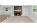 Bright living room with fireplace, hardwood floors, and a large window at 2752 Weldon Ter, Durham, NC 27703