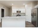 Bright kitchen boasts granite countertops, stainless appliances, and white cabinetry for a clean, modern look at 2807 Ricolden Trl, Elon, NC 27244