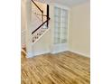 Sunlit living room featuring wood floors and built-in bookshelves next to the staircase at 306 Fincastle Dr, Cary, NC 27513