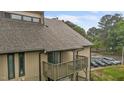 View of condo exterior with a wooden balcony and view of parking lot at 3077 Huntleigh Dr, Raleigh, NC 27604