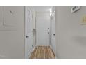 Bright hallway with hardwood flooring and a white front door at 3077 Huntleigh Dr, Raleigh, NC 27604