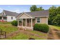 Inviting front of a cozy home featuring a covered porch and well-maintained lawn at 325 Martin Luther King Jr Blvd, Raleigh, NC 27601