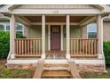 Close-up of a quaint porch with stone accents and sturdy wooden railings at 325 Martin Luther King Jr Blvd, Raleigh, NC 27601