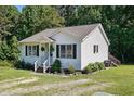 Quaint single-story home with a cozy porch, complemented by landscaped garden and lawn at 364 Chinaberry Ln, Angier, NC 27501