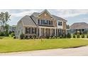 Well-maintained two-story home with black shutters and a lovely manicured front lawn at 367 Tayside St, Clayton, NC 27520