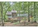 Secluded backyard with beautiful wooden deck and surrounding lush trees offers a private outdoor retreat at 3910 Somerset Dr, Durham, NC 27707