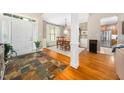 Open foyer featuring slate floors and an adjacent dining room with wooden floors and a bright window at 3916 Rustic Mill Dr, Apex, NC 27539