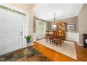 Open foyer featuring slate floors and an adjacent dining room with wooden floors and a bright window at 3916 Rustic Mill Dr, Apex, NC 27539