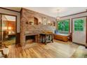 Inviting living room featuring a cozy fireplace, wood accents, and a scenic view from the window at 4272 Boyd Wright Rd, Burlington, NC 27215