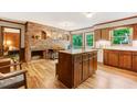 Inviting living room featuring wood cabinets, brick fireplace, and a beautiful view of nature at 4272 Boyd Wright Rd, Burlington, NC 27215