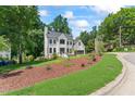 Beautiful home with a well-kept lawn and fresh mulch in a serene, tree-lined neighborhood at 4408 Queenstown Ct, Raleigh, NC 27612