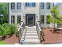 Close up of front porch with freshly painted brick steps leading to a black modern front door at 4408 Queenstown Ct, Raleigh, NC 27612