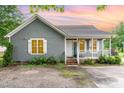 Charming single-story home featuring gray wood shingles, white trim, and a welcoming front porch with a small yard at 4575 Wendell Blvd, Wendell, NC 27591