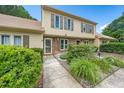 Charming townhome with a landscaped front yard, and a welcoming entrance walkway at 46 Sparger Springs Ln, Durham, NC 27705