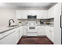 Bright kitchen features white cabinets, granite countertops, stainless microwave, and modern appliances at 46 Sparger Springs Ln, Durham, NC 27705