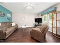 Bright living room featuring hardwood floors, comfortable seating and natural light from the window at 46 Sparger Springs Ln, Durham, NC 27705