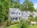 Two-story home with a welcoming front porch, attached garage, and a well-manicured lawn at 4705 Royal Troon Dr, Raleigh, NC 27604