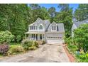 Well-maintained two-story home with a welcoming front porch and lush landscaping at 4705 Royal Troon Dr, Raleigh, NC 27604