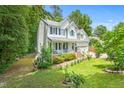 Beautifully landscaped two-story home with a covered front porch and attached garage at 4705 Royal Troon Dr, Raleigh, NC 27604