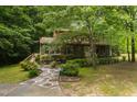 Two-story house with stone pathway, landscaped yard, and lush, mature trees at 4710 Rollingwood Dr, Durham, NC 27713