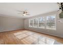Spacious living room features hardwood floors, ceiling fan, and large windows, perfect for entertaining at 4720 Brigadoon Dr, Durham, NC 27705