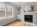 Inviting living room with fireplace and ample natural light streaming through large windows at 4720 Brigadoon Dr, Durham, NC 27705