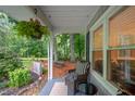 Relaxing screened porch with comfortable seating and view of the serene, wooded backyard at 4777 Helena Moriah Rd, Rougemont, NC 27572
