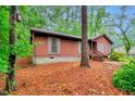 Cozy single-story home with wood siding, offering a glimpse of natural beauty and a tranquil setting at 506 E E St, Butner, NC 27509