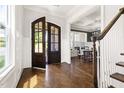 Elegant foyer with hardwood floors, showcasing the entry to the dining room and beautiful staircase at 5100 Schellinger, Raleigh, NC 27612