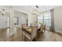 Dining room with a modern chandelier and large windows that provide lots of natural light at 60 Silent Brook Trl, Franklinton, NC 27525