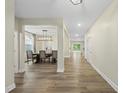 Inviting hallway with wood flooring leading to the dining area and backyard at 60 Silent Brook Trl, Franklinton, NC 27525