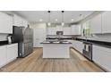 Modern kitchen with white cabinets, granite countertops and stainless steel appliances at 60 Silent Brook Trl, Franklinton, NC 27525