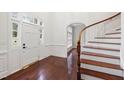 Inviting foyer with hardwood floors and a beautiful curved staircase at 636 Pendleton Lake Rd, Raleigh, NC 27614