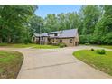 Beautifully landscaped home with circular driveway and Tudor style architecture at 6617 Whitted Rd, Fuquay Varina, NC 27526
