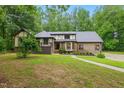 Charming home with a blend of brick and Tudor-style architecture, complemented by a well-maintained lawn and walkway at 6617 Whitted Rd, Fuquay Varina, NC 27526