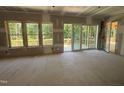 Spacious room featuring sliding doors leading to a new wooden deck overlooking a wooded area at 79 Oldham Estate Dr, Chapel Hill, NC 27517