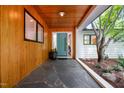 Inviting entryway boasting a wood-paneled accent wall and stylish blue door at 800 Shady Lawn Rd, Chapel Hill, NC 27514