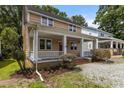 Charming home featuring a covered front porch with classic white columns and well maintained landscaping at 803 W Club Blvd, Durham, NC 27701