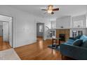 Bright living room featuring hardwood floors, a decorative brick fireplace, and ample natural light at 803 W Club Blvd, Durham, NC 27701