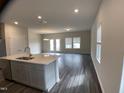 Open-concept living and kitchen area features dark floors, recessed lights, and a kitchen island at 909 Clearhaven Ln # 909, Fuquay Varina, NC 27526