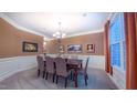Spacious dining room featuring wainscoting, a chandelier, and large windows at 99 Grassy Creek Way, Chapel Hill, NC 27517