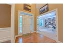 Inviting foyer with hardwood floors, complemented by views into the library at 99 Grassy Creek Way, Chapel Hill, NC 27517