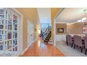 Open hallway with hardwood floors leading to the dining room and staircase at 99 Grassy Creek Way, Chapel Hill, NC 27517