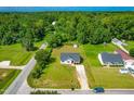 Aerial view of a well-situated home with a long drive in a lush green neighborhood at 101 Kristina Dr, Selma, NC 27576
