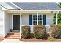 Inviting front porch with brick steps, manicured bushes and a dark front door at 101 Kristina Dr, Selma, NC 27576