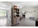 Cozy living room showcasing a fireplace, vaulted ceiling, and modern gray flooring at 101 Kristina Dr, Selma, NC 27576