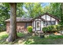 Exterior view of a well-maintained home with brick accents and a lush green lawn and mature trees at 103 Castill Pl, Garner, NC 27529
