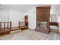 The living room features a brick fireplace and a landing with wood railing at 103 Castill Pl, Garner, NC 27529