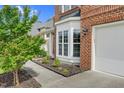 Close-up of the brick exterior with a bright bay window and a two-car garage door at 106 Elmsford St, Durham, NC 27703