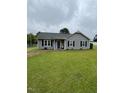 Single-story home with gray siding, black shutters and a well-manicured lawn at 109 D A King Dr, Willow Springs, NC 27592